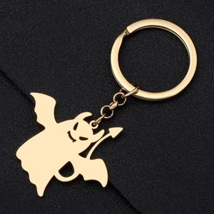 Porte-clés petit diable doré en acier inoxydable avec ailes et lance sur fond noir
