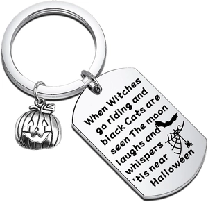 Macro shot of stainless steel pumpkin keychain with engraved Halloween poem and bats