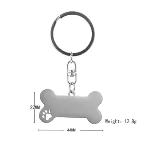 Silver stainless steel bone shaped keychain with hollow paw print and rotating hook clasp