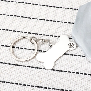 Silver stainless steel bone shaped keychain with hollow dog paw design for pets