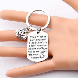 Stainless steel Halloween pumpkin keychain with engraved rectangular tag on white background