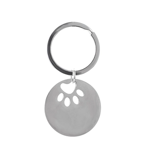 Detailed close-up of a silver stainless steel dog tag keychain with hollow paw print design