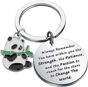 Macro detail of enamel panda keychain with laser engraved motivational metal tag