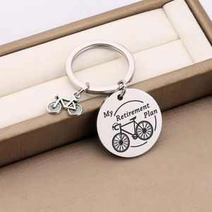 Stainless steel bicycle keychain with Retirement Plan engraving on a jewelry box