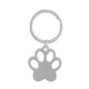 Close-up of polished stainless steel paw print keychain with engravable round ring