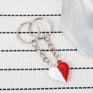 Couples interlocking heart puzzle keychain set with martial arts relief design