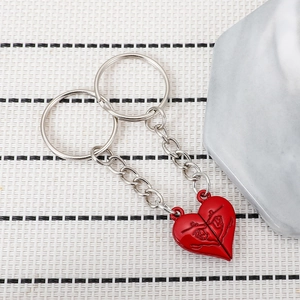 Detailed view of silver metal interlocking heart keychains with red enamel finish