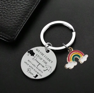 Rainbow enamel charm and engraved stainless steel keychain on black leather background