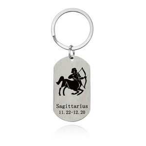 Macro detail of Sagittarius stainless steel keychain with brushed metal texture