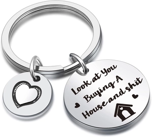 Detailed view of stainless steel housewarming keychain with funny house moving engraving