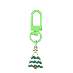 Detailed view of metal alloy Christmas tree charm with green enamel and lobster clasp