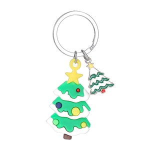 Detail view of cartoon PVC Christmas tree keychain with colorful dots and metal ring