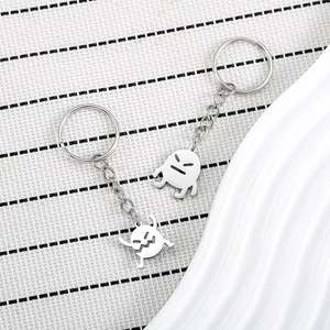 Macro shot of polished stainless steel soot sprite keychains with minimalist expressions