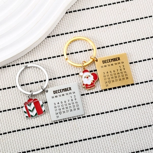 Porte-clés calendrier de Noël en or et argent avec charms Père Noël et cadeaux