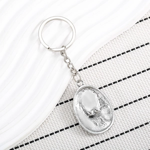 Vintage silver eagle keychain featuring a detailed skull embossed metal pendant design
