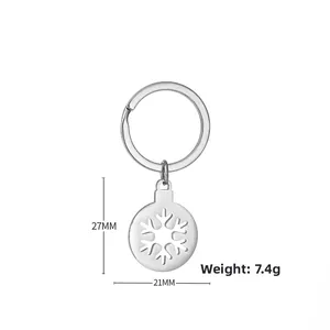 Close-up of silver Christmas snowflake keychain with 27mm diameter and measurements