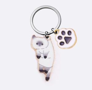Detail view of Siamese cat and purple paw charms on a durable alloy metal keychain