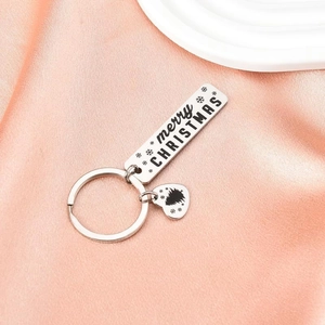 Polished silver Christmas keychain with Merry Christmas engraving on a silk background