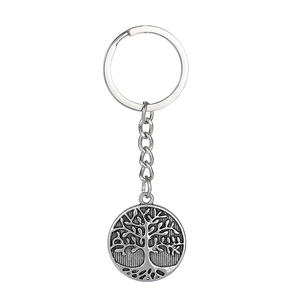 Macro detail of Tree of Life metal keychain with vintage silver finish and engraved texture
