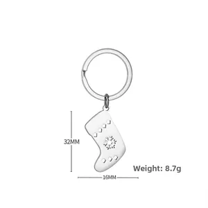 Detail view of silver stainless steel Christmas stocking keychain with snowflake cutout