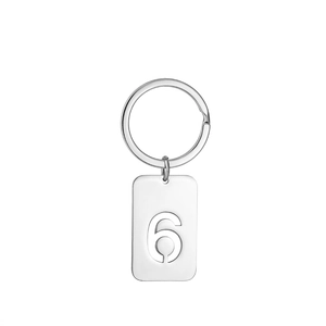 Macro shot of silver stainless steel keychain featuring a hollow number 6 rectangular tag