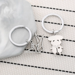 Stainless steel origami crane and heart-shaped character charm keychain set in silver