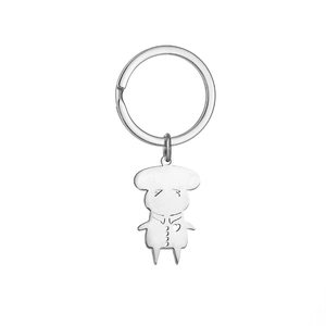 Macro detail of cartoon sheep character keychain in polished silver stainless steel