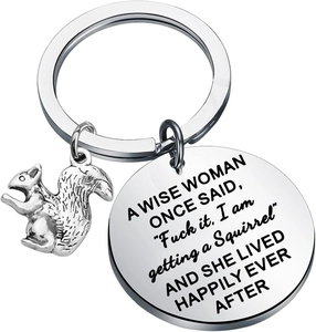 Macro shot of polished stainless steel squirrel charm with funny quote engraving