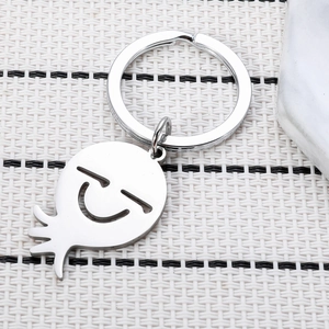 Porte-clés en Acier Inoxydable Poulpe Souriant Design Creux Pendentif de Sac Dessin Animé Argent Métallique Unisexe Cadeau