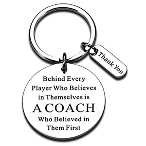 Detail of silver stainless steel keychain with engraved motivational coach quote and thank you tag