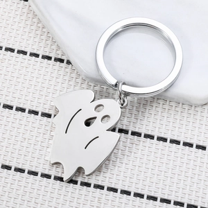 Ghost stainless steel keychain with polished silver finish on white woven background