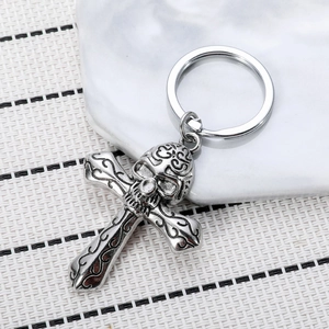 Retro gothic skull and cross keychain with intricate vine patterns in silver finish