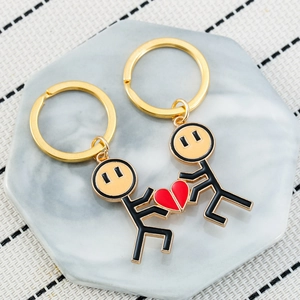 Matching couple keychain set with gold stick figures and magnetic red heart charm
