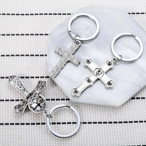 Gothic skull cross keychain set in vintage silver alloy on a marble tray