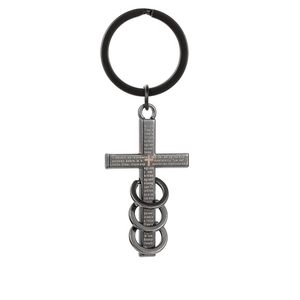 Macro detail of gunmetal cross keychain with Spanish scriptures and three rings