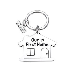 Polished silver stainless steel house-shaped keychain engraved with Our First Home 2024