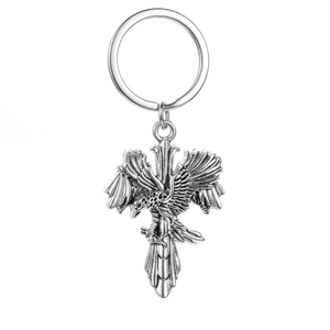 Detail of vintage eagle cross keychain with antique silver finish and 3D relief texture