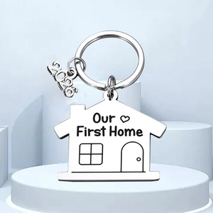 Polished stainless steel house-shaped keychain with Our First Home engraving and 2026 charm