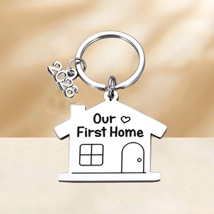 Polished stainless steel house-shaped keychain with Our First Home 2026 engraving