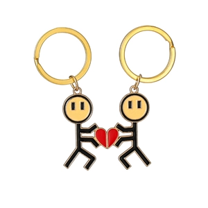 Detail of magnetic stick figure couple keychains with matching red heart puzzle parts