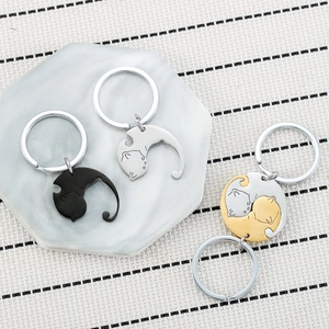Minimalist spinning cat couple keychains set in black, silver, and golden finish