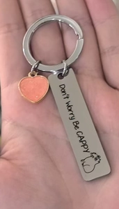 Detail of Capybara stainless steel keychain with engraved Don't Worry Be Cappy text