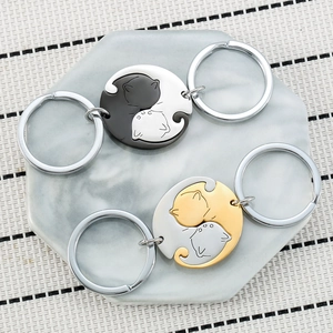 Rotating black and white cat couples keychain set in yin yang design on marble tray