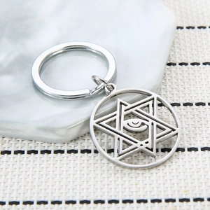 Polished stainless steel evil eye keychain with geometric hexagram star pendant design