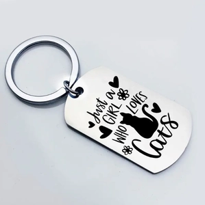 Detail of silver stainless steel cat keychain with Just a GIRL WHO LOVES CATS engraving