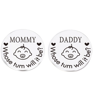 Detailed close-up of engraved stainless steel parenting decision coins in silver