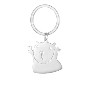 Close-up of a silver stainless steel capybara keychain holding a heart shaped charm