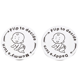 Close-up of stainless steel decision coins with Mummy's turn and Daddy's turn engraving