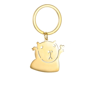 Close-up of golden capybara keychain with polished finish and tiny heart detail