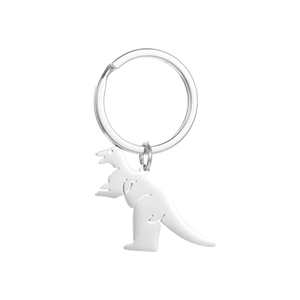 Detailed macro view of a polished stainless steel dinosaur keychain with a silver finish